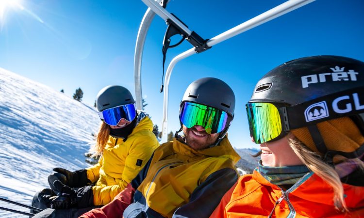 2 person in yellow jacket wearing helmet riding on cable car during daytime